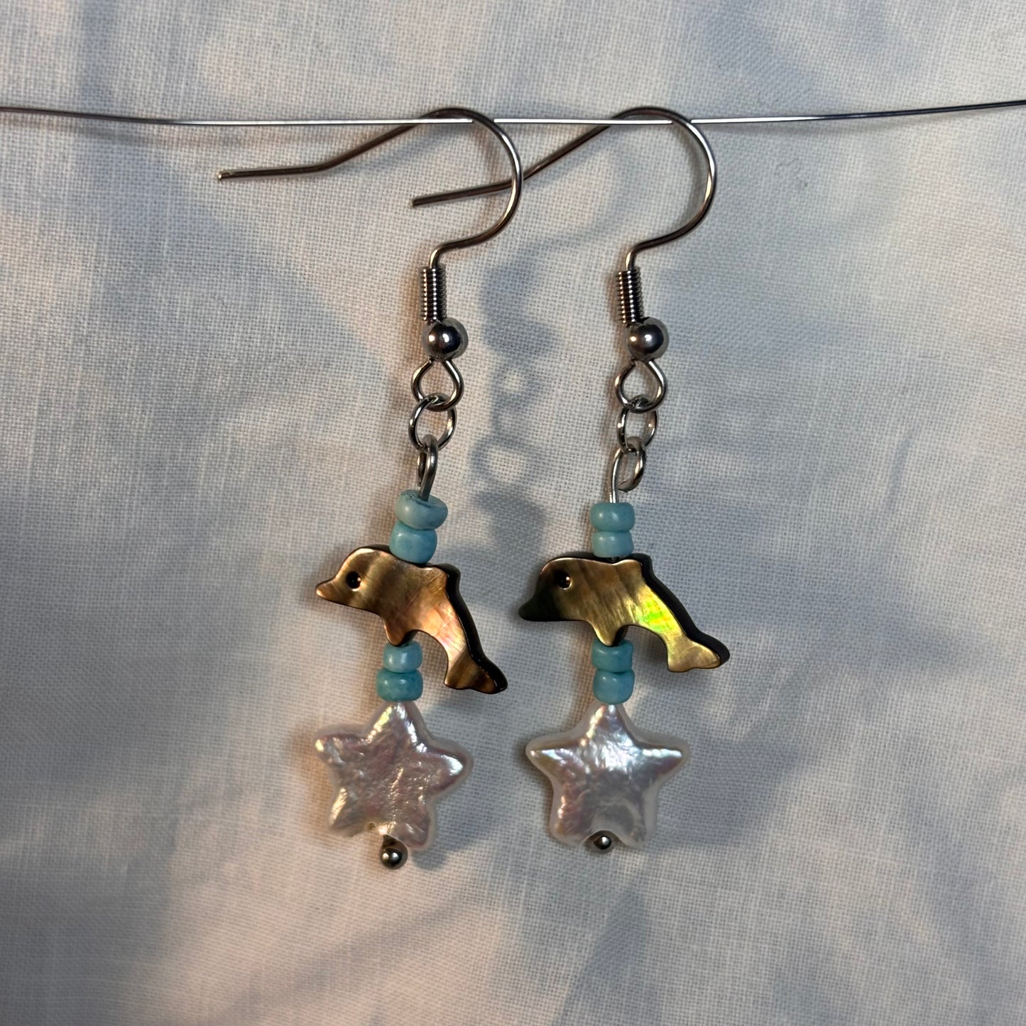 shell dolphin, pearl, and glass beaded earrings