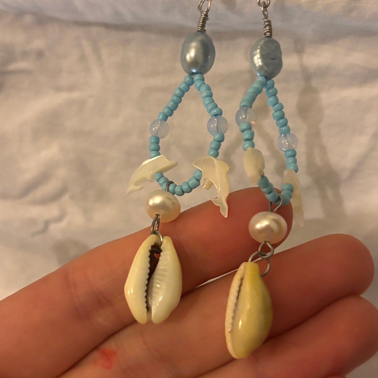 shell dolphin, pearl, and cowrie shell beaded loop earrings