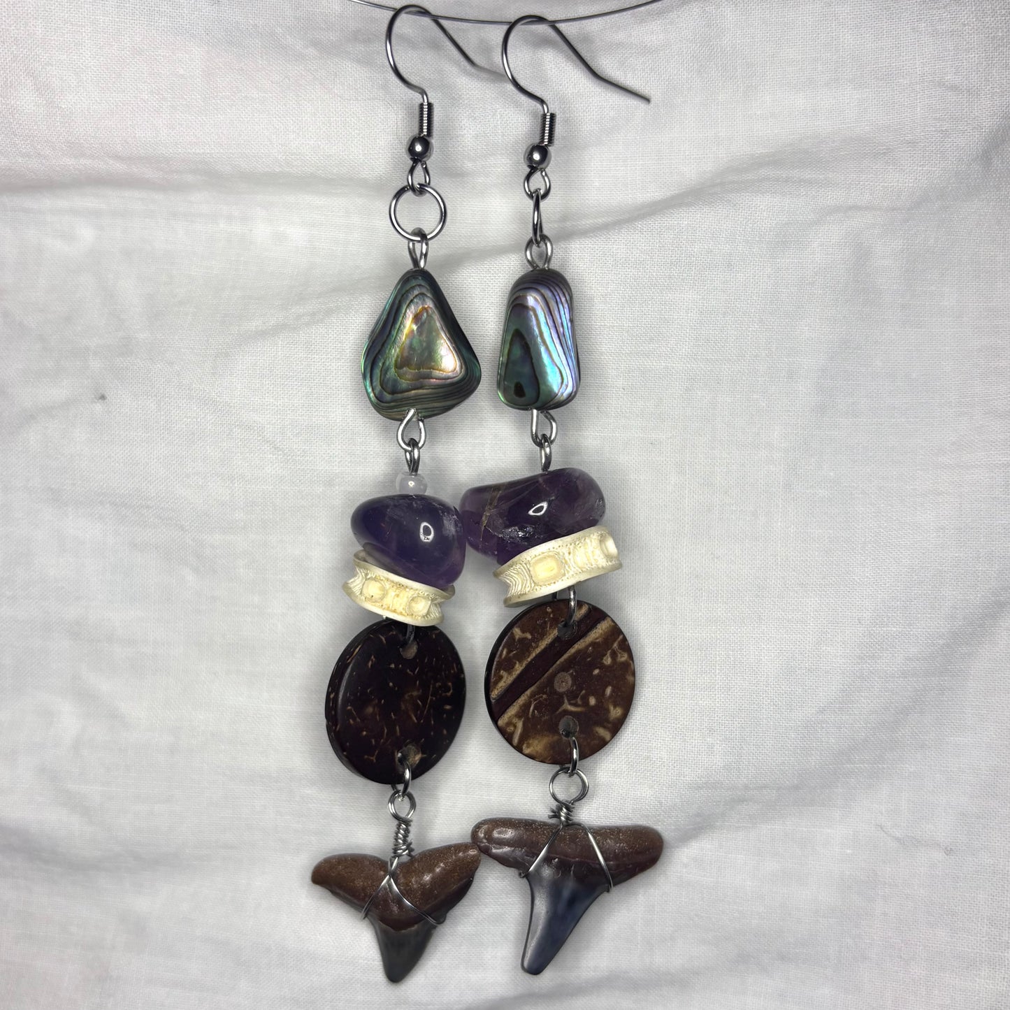 shark tooth, abalone, coconut, amethyst, and fish vertebrae earrings