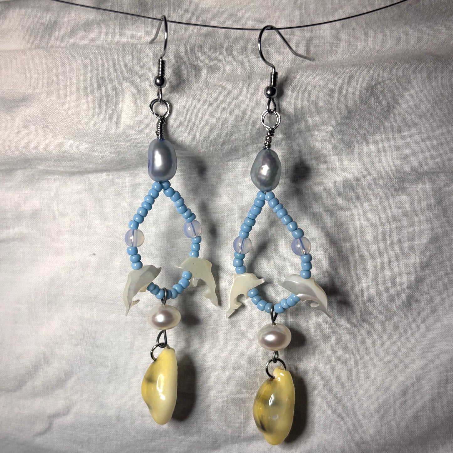 shell dolphin, pearl, and cowrie shell beaded loop earrings