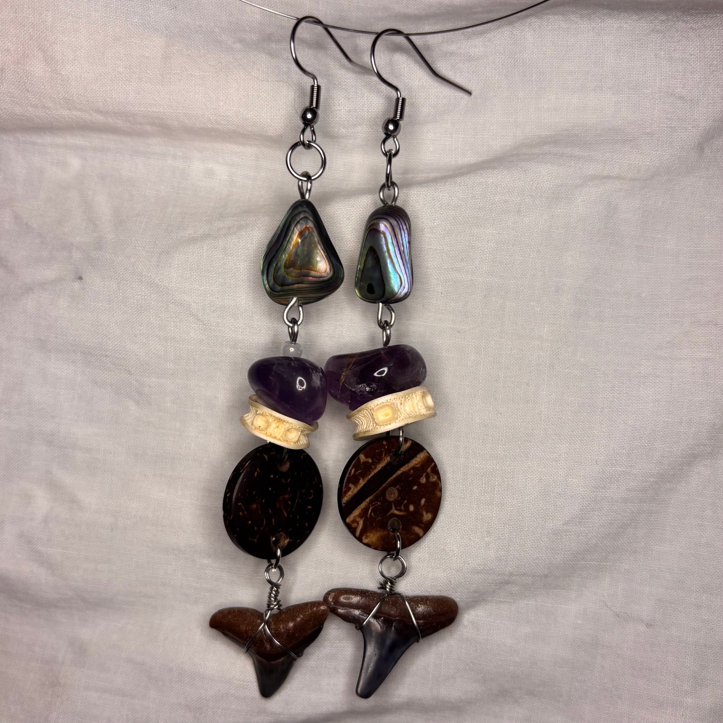 shark tooth, abalone, coconut, amethyst, and fish vertebrae earrings