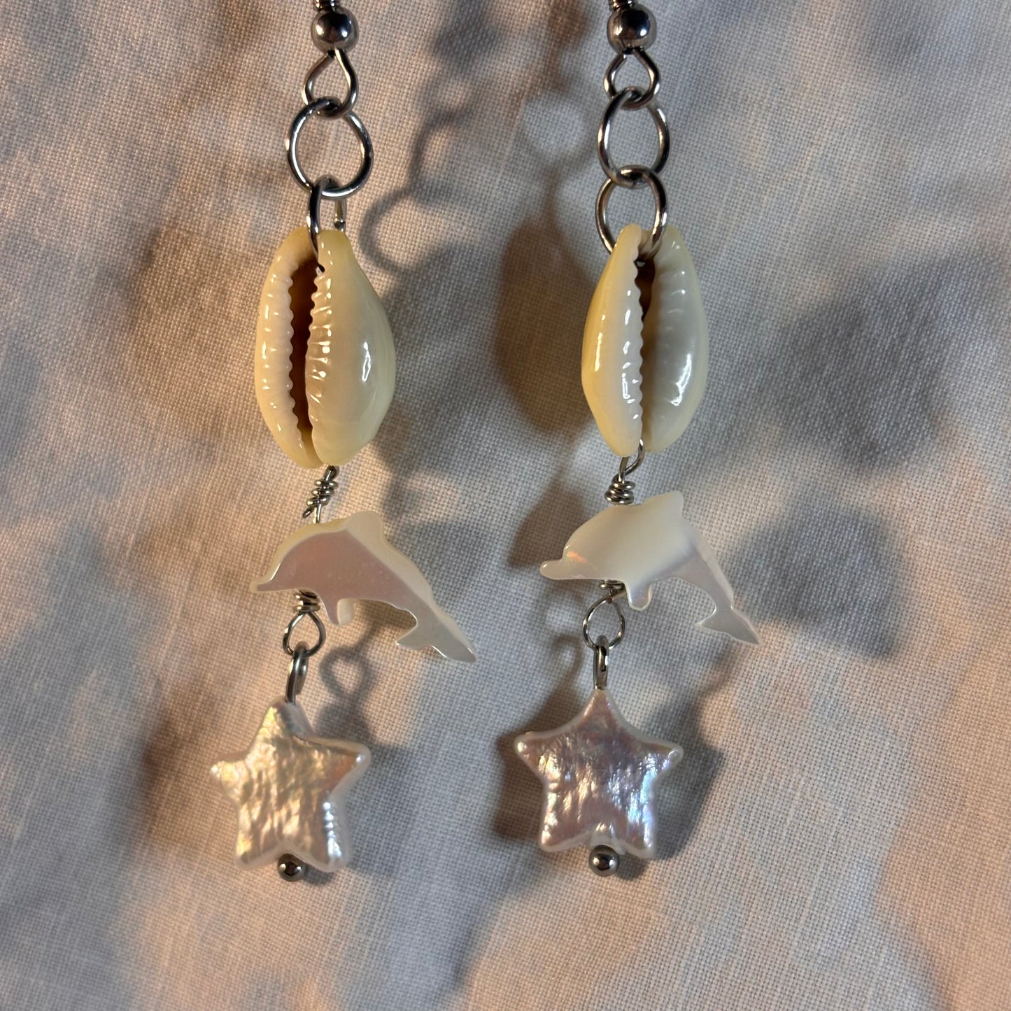 cowrie shell, pearl, and shell dolphin earrings